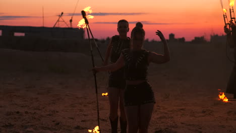 Professional-dancers-women-make-a-fire-show-and-pyrotechnic-performance-at-the-festival-with-burning-sparkling-torches